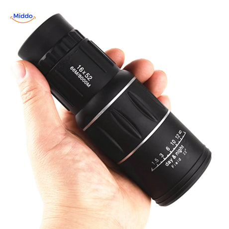 High magnification night vision scope held in hand for portable viewing.