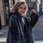 Heated hoodie in stylish dark grey worn by model in a relaxed lifestyle setting.