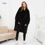 Black heated sweater worn by model showing the cozy relaxed fit in a lifestyle setting.