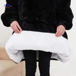 Close-up of the heated sweater's black outer shell and soft warm white interior lining.