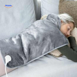 Person lying down while using heating pad for back and shoulder relaxation therapy.