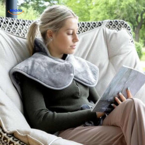 Person outdoors relaxing and reading with heating pad for portable comfort anywhere.