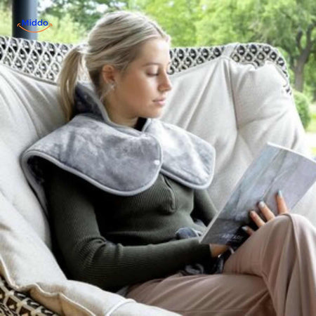 Person outdoors relaxing and reading with heating pad for portable comfort anywhere.