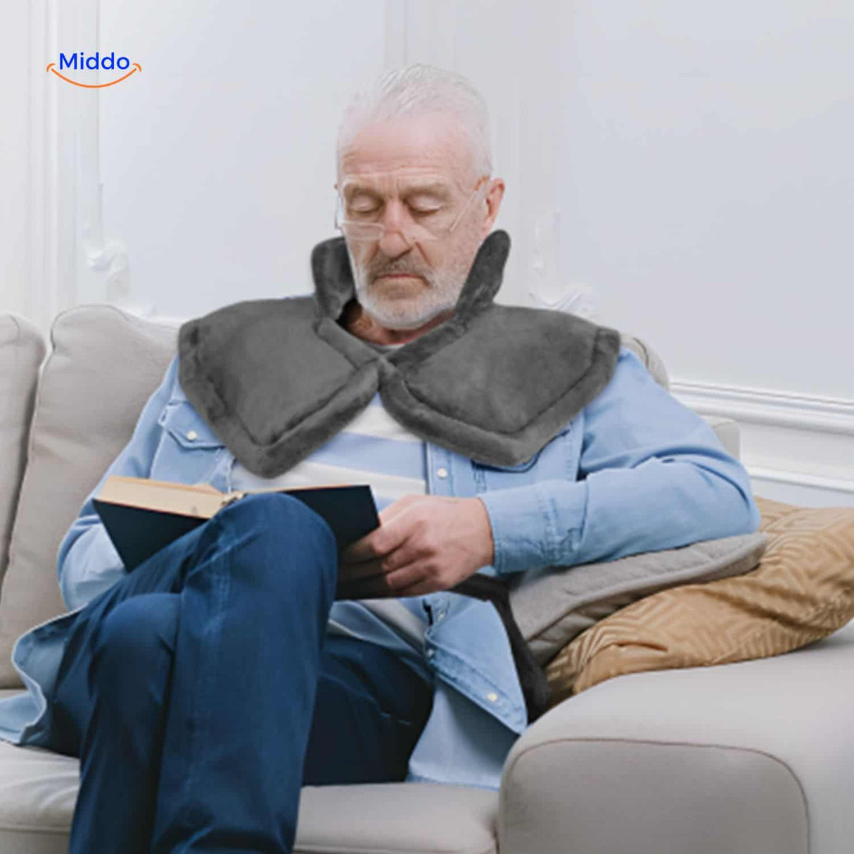 Senior person enjoying relaxation with heating pad therapy for muscle and joint comfort.