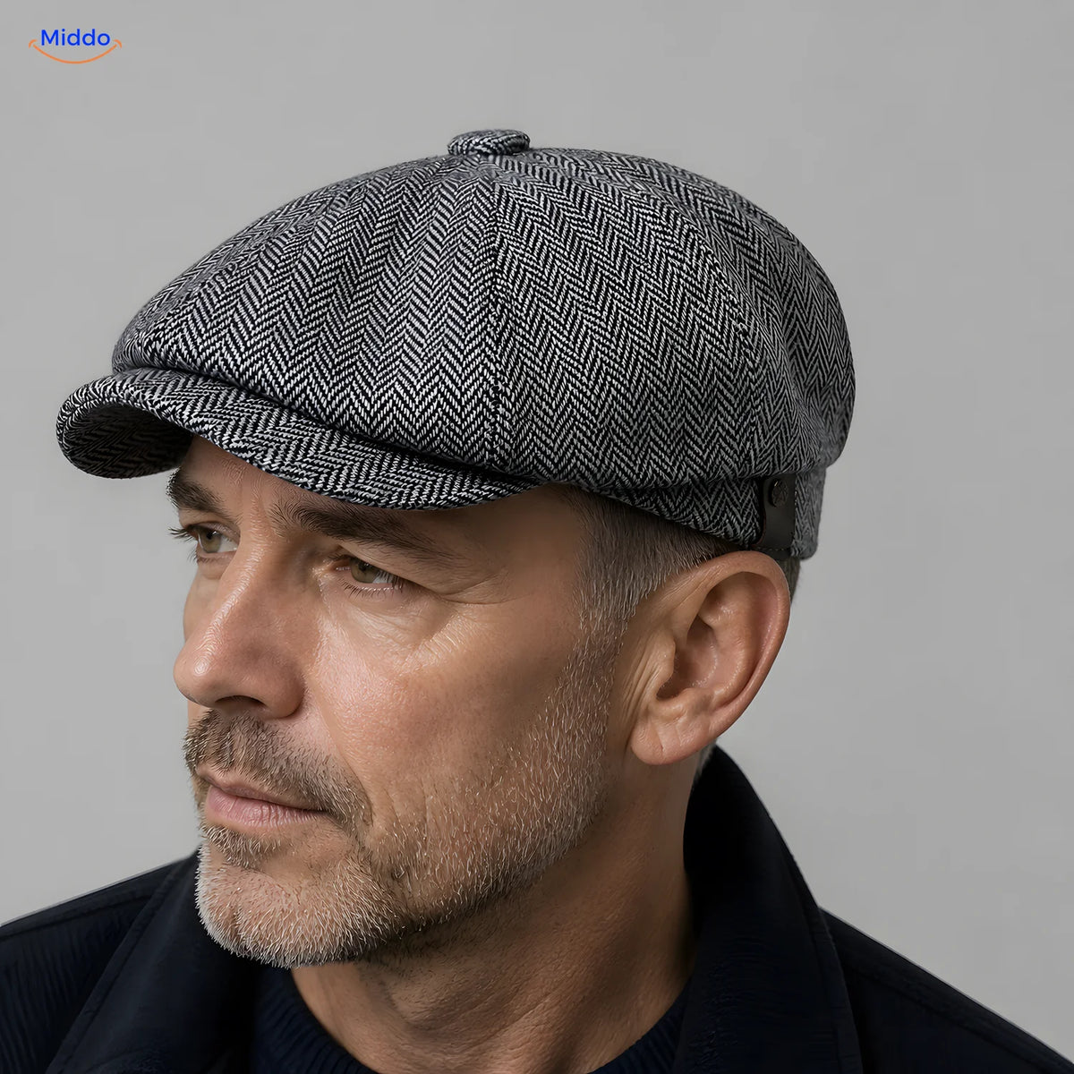 Close-up of a gray Heritage Eight flat cap with a short brim and eight panels