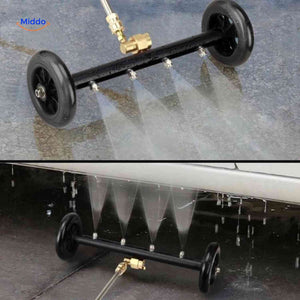 Powerful water jet stream from undercarriage cleaner during car cleaning.