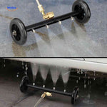 Powerful water jet stream from undercarriage cleaner during car cleaning.