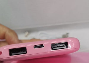 Huggy heated pad showing pink design and power connection details.