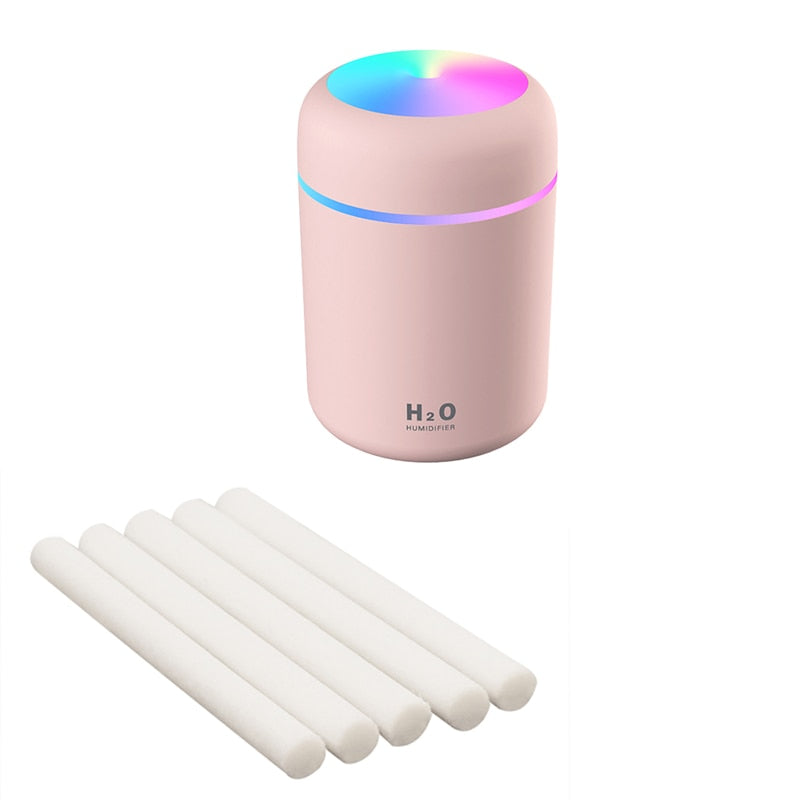 Grey humidifier with included extra cotton swabs for aromatherapy diffusion.