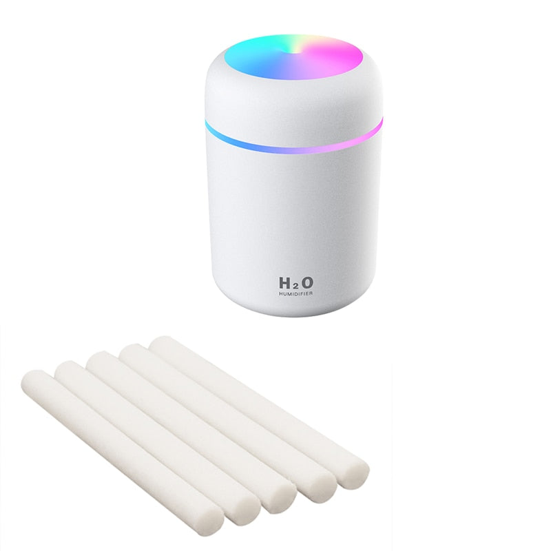 White humidifier model with replacement cotton swabs for essential oil diffusing.