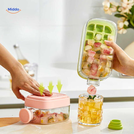 Ice bottle being emptied with fruit ice cube catch tray and green lid