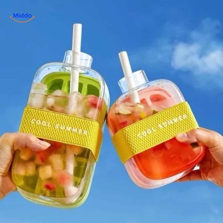 Two ice bottles with fruit drink and straws outdoors