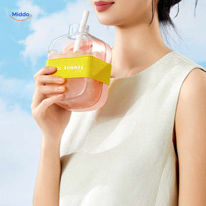 Pink ice bottle with summer drink and carrying strap, close-up view