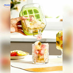 Ice bottle pouring colorful fruit-infused ice cubes into a glass