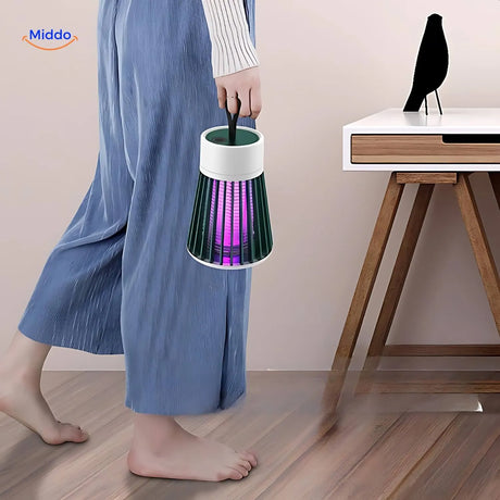 Compact InstaZap mosquito lamp fits in hand showing portable lightweight design.