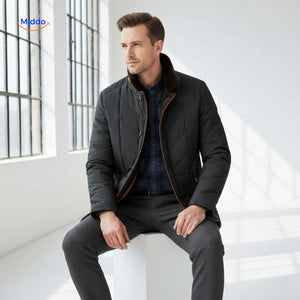Man wearing quilted jacket indoors by window with natural light.