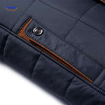 Quilted jacket pocket detail with button and stitching visible.