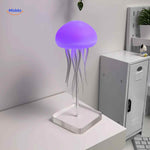 Blue JellyGlow jellyfish lamp on desk creating atmospheric light.
