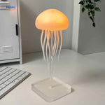 Warm orange JellyGlow lamp illuminating with soft LED light.