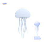 White JellyGlow jellyfish-shaped lamp on transparent stand.