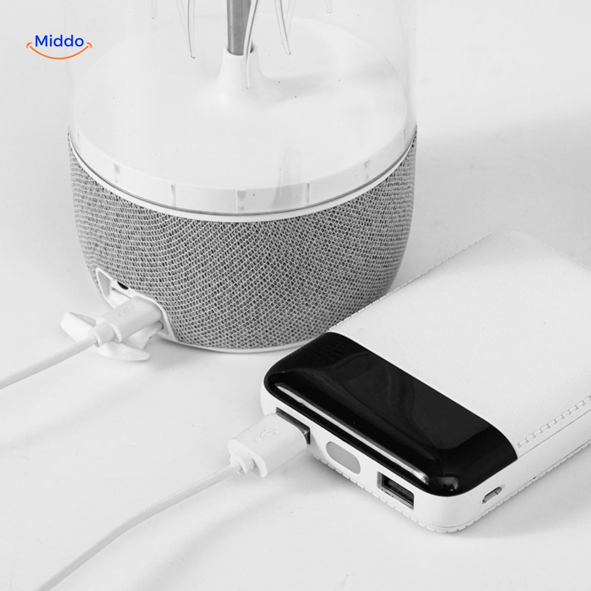 Close-up of JellyGlow portable speaker being charged with USB cable connection.