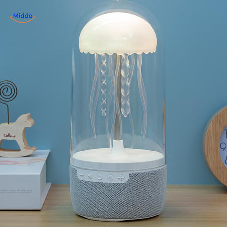 JellyGlow mini speaker with warm ambient lighting illuminating a home desk setup.