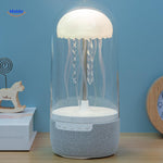JellyGlow mini speaker with warm ambient lighting illuminating a home desk setup.