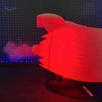 Jetfan turbofan with glowing red tail flame illuminated in dark ambient light.