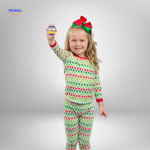 Child holding a completed hand-painted wooden ornament created with TreeMendous kit.
