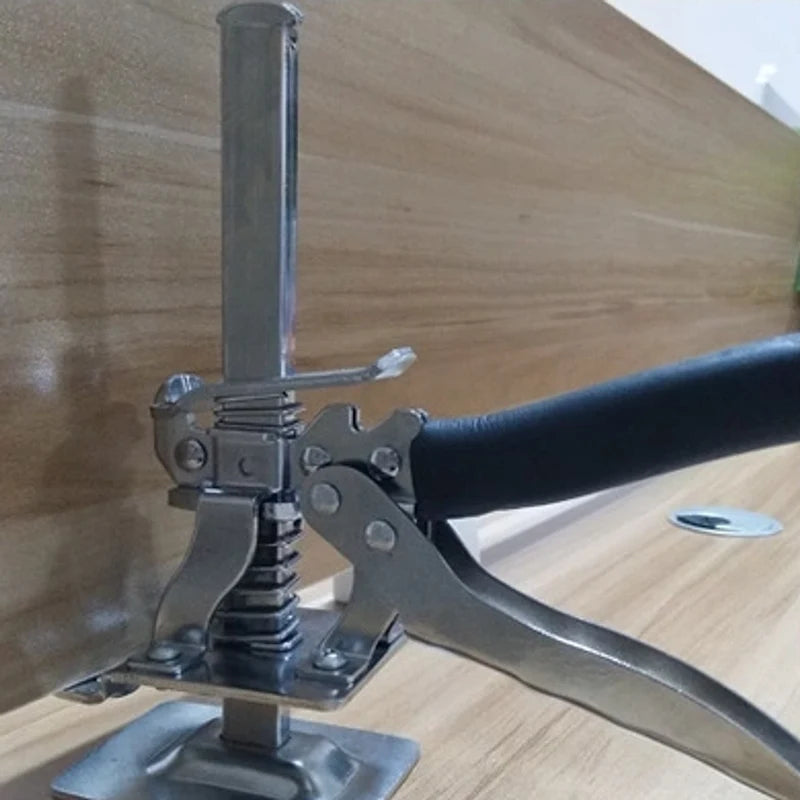 Real supplier photo of a silver compact KrikFix lifting a wooden panel on its front support ridges