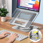 Adjustable 360 laptop stand styled with plants on a wooden desk workspace.