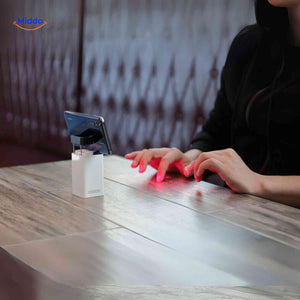 Laser projection keyboard connected to desktop computer setup.