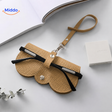 Compact glasses case featuring elegant leather construction for secure eyewear storage.