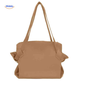 Foldable leather shopper with long shoulder strap for comfortable carry.