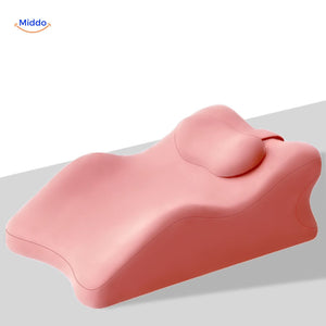Pink leg elevation pillow featuring integrated head and neck rest functionality.