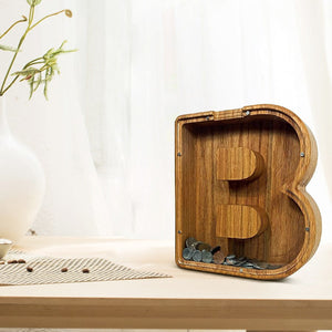 Wooden letter B piggy bank filled with coins, encouraging children's savings habits.