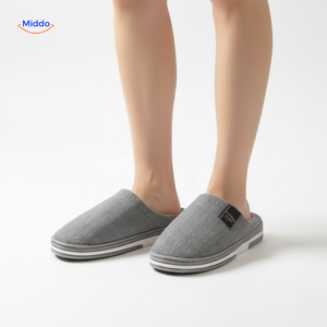 Women's light gray slippers with durable non-slip sole.