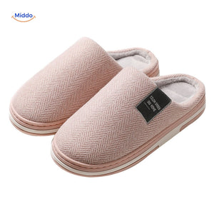 Close-up detail of light pink soft cotton slippers.