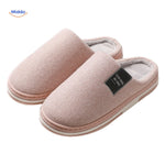 Close-up detail of light pink soft cotton slippers.