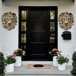 Golden lion head resin sculpture mounted on an entryway wall with modern home decor.