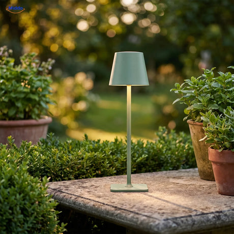 Green Lumiset table lamp on a garden table