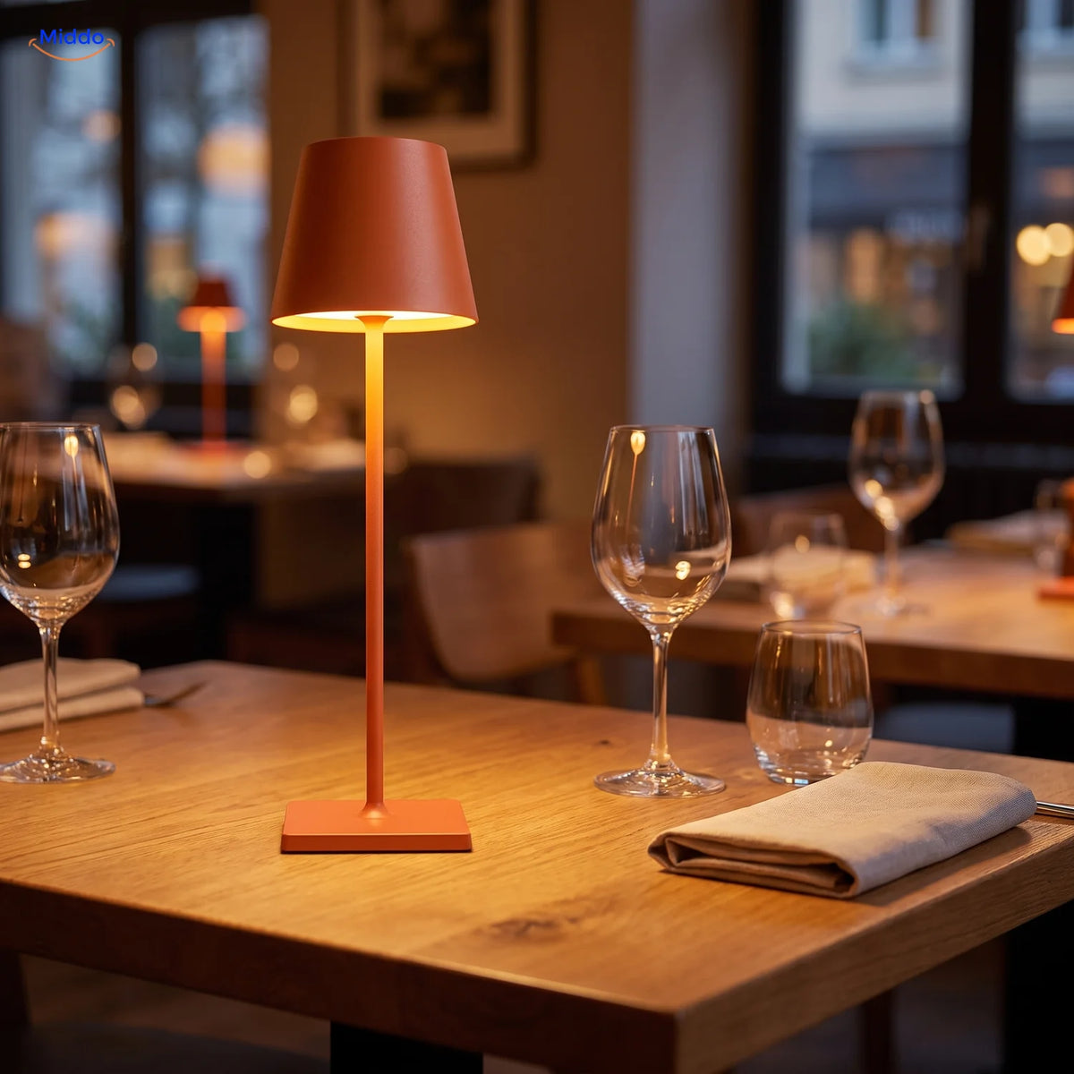 Orange Lumiset table lamp on a restaurant table