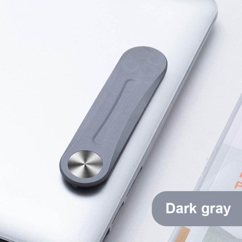 Gray MagnetClip magnetic phone mount folded and secured on laptop screen.