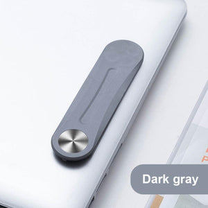 Gray MagnetClip magnetic phone mount folded and secured on laptop screen.