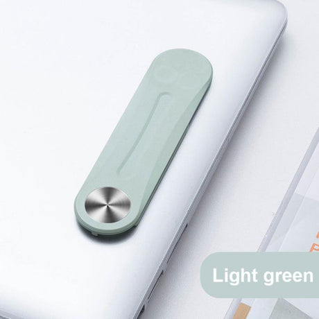 Green MagnetClip phone mount folded and positioned on laptop for second screen setup.