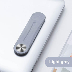 Light grey MagnetClip phone mount secured on laptop for dual-screen workstation setup.