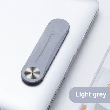 Light grey MagnetClip phone mount secured on laptop for dual-screen workstation setup.