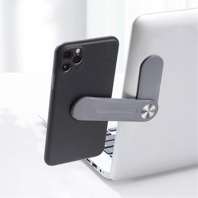 MagnetClip magnetic phone mount attached to laptop for hands-free video calls and dual-screen productivity.
