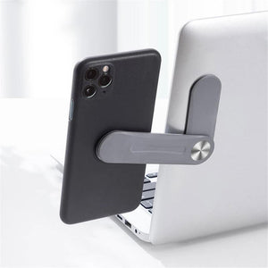 MagnetClip magnetic phone mount attached to laptop for hands-free video calls and dual-screen productivity.