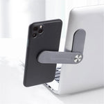 MagnetClip magnetic phone mount attached to laptop for hands-free video calls and dual-screen productivity.